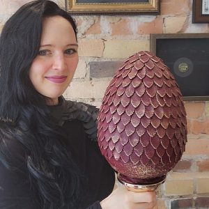 Sam Lapointe holds the $1000 Chocolate Dragon Egg up for grabs in The Grand Hunt on March 23rd